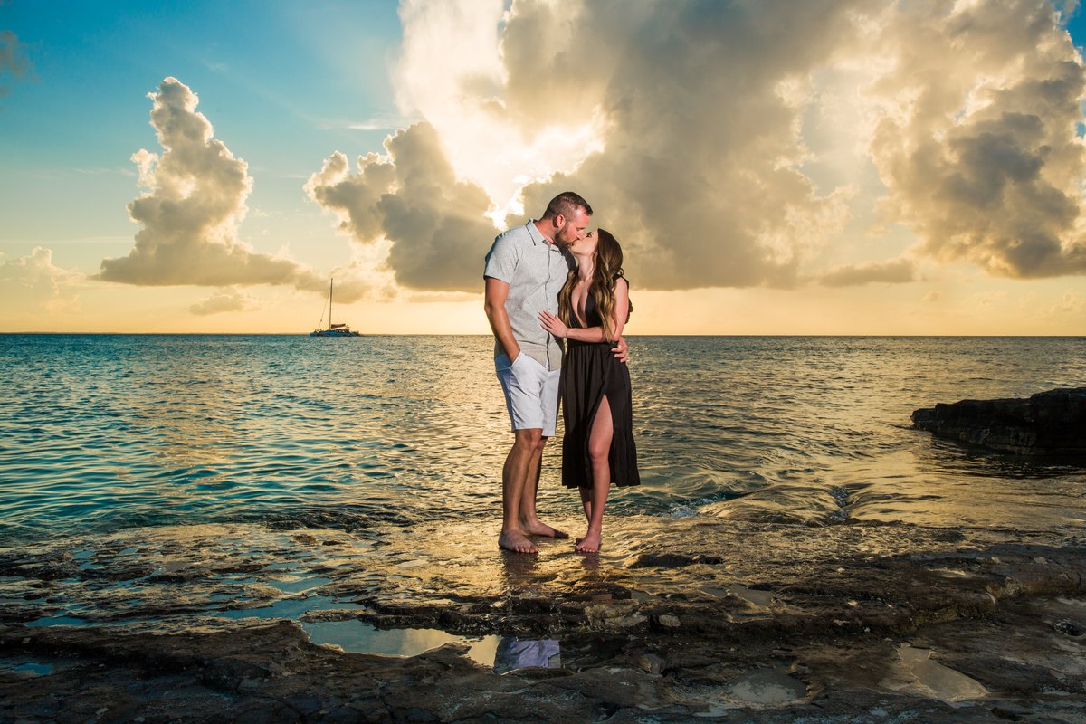 A couple sharing a kiss at sunset on a Turks & Caicos beach