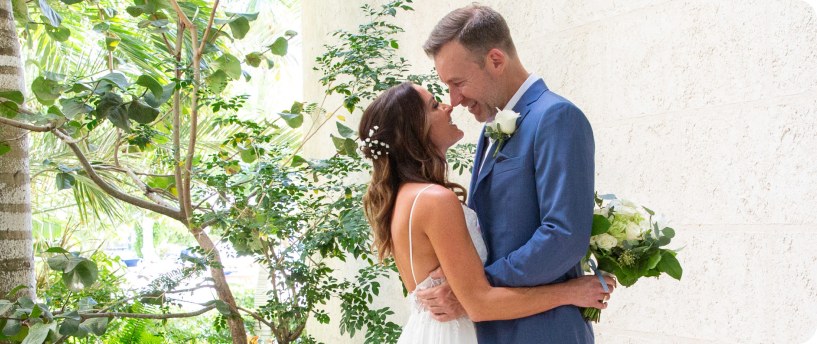 A bride and groom embracing in a Turks & Caicos garden