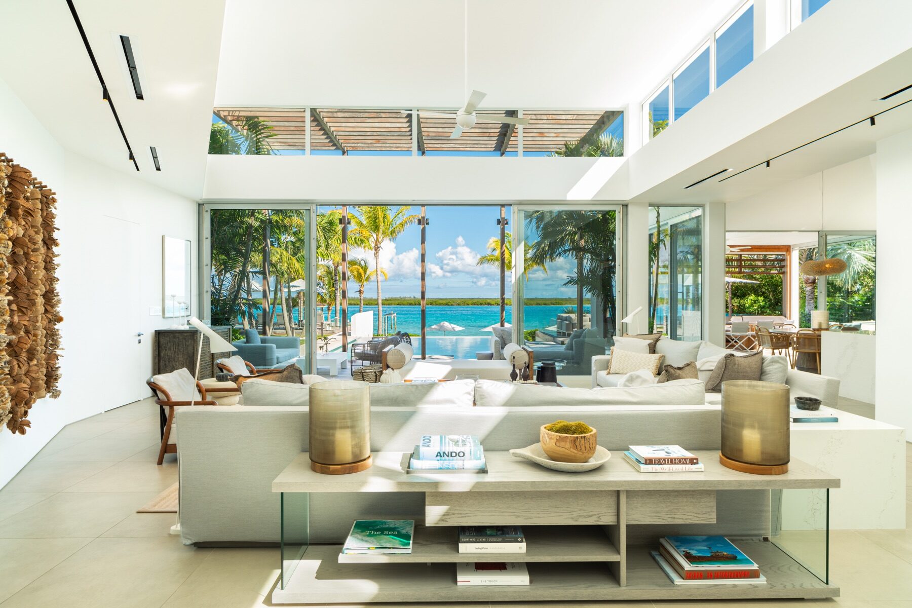 Open concept living room with ocean views through floor to ceiling glass