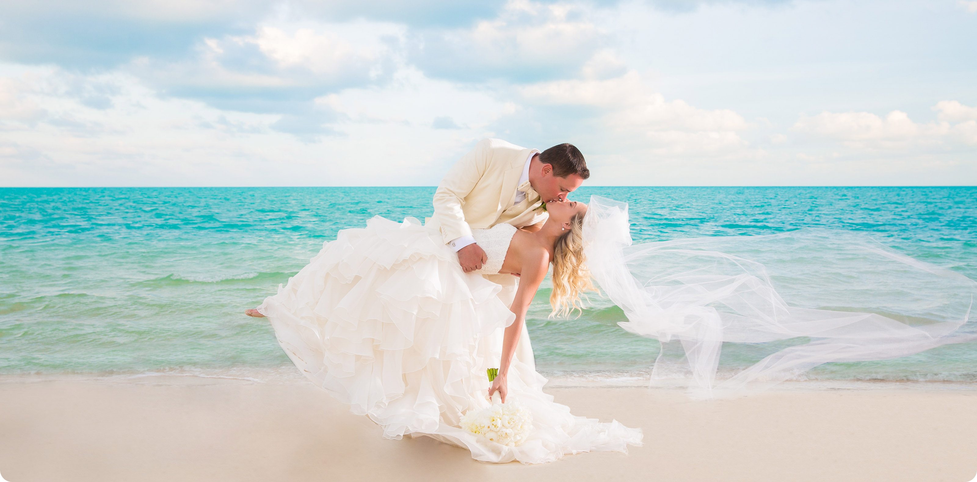 Bride and groom sharing a dip kiss on a Turks & Caicos beach