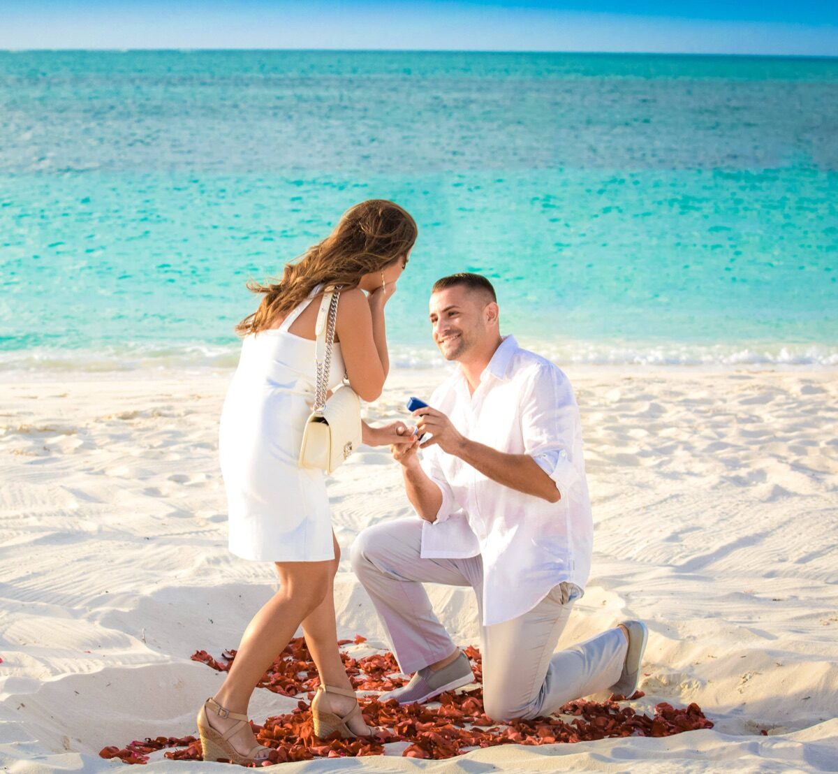 Just-engaged couple celebrating on the beach in Turks and Caicos